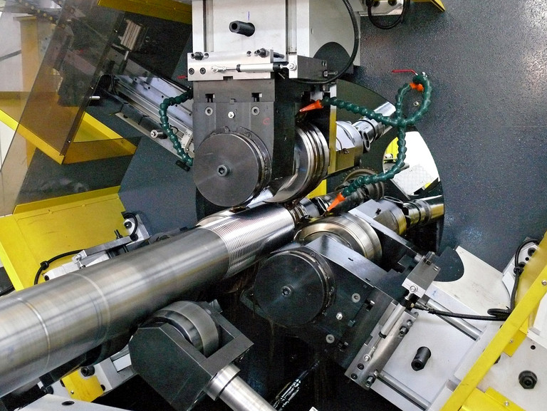 The thread rolling machine in operation.